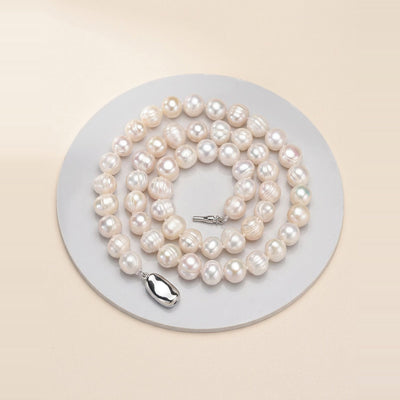 Baroque Pearl Strand Necklace in Pearl, laid flat on a surface.