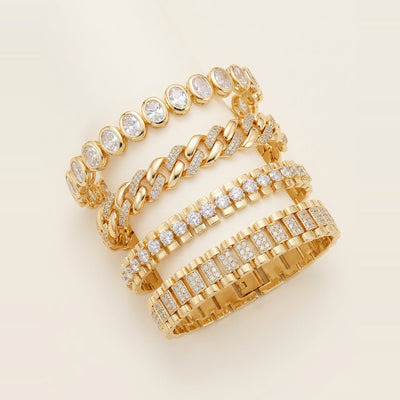 Four gold-toned link bracelets stacked on a wrist in Gold.