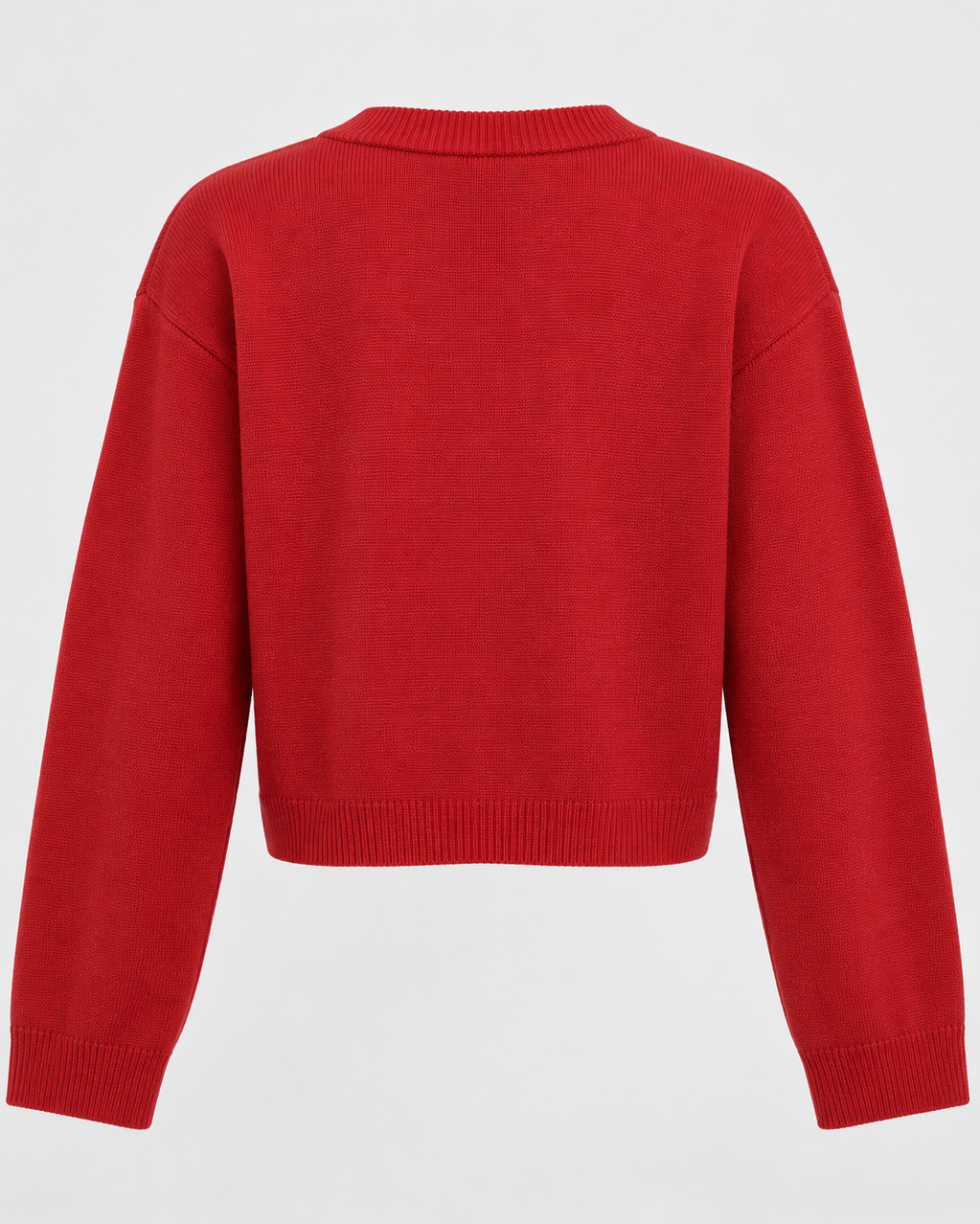 Close view of fine-gauge knit cardigan showing button placket and ribbed cuff