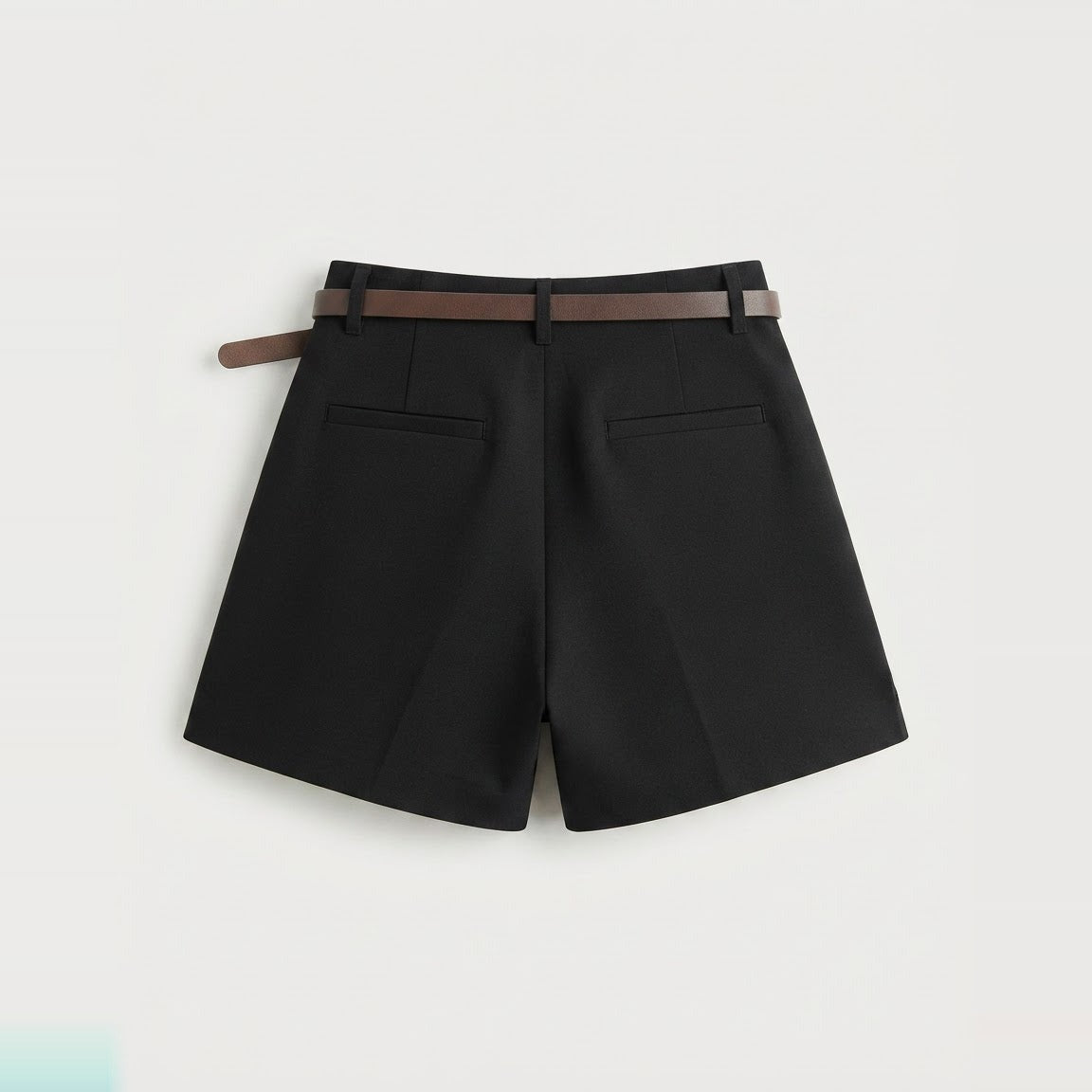 Black tailored shorts showing belt loops, side pocket and clean hem