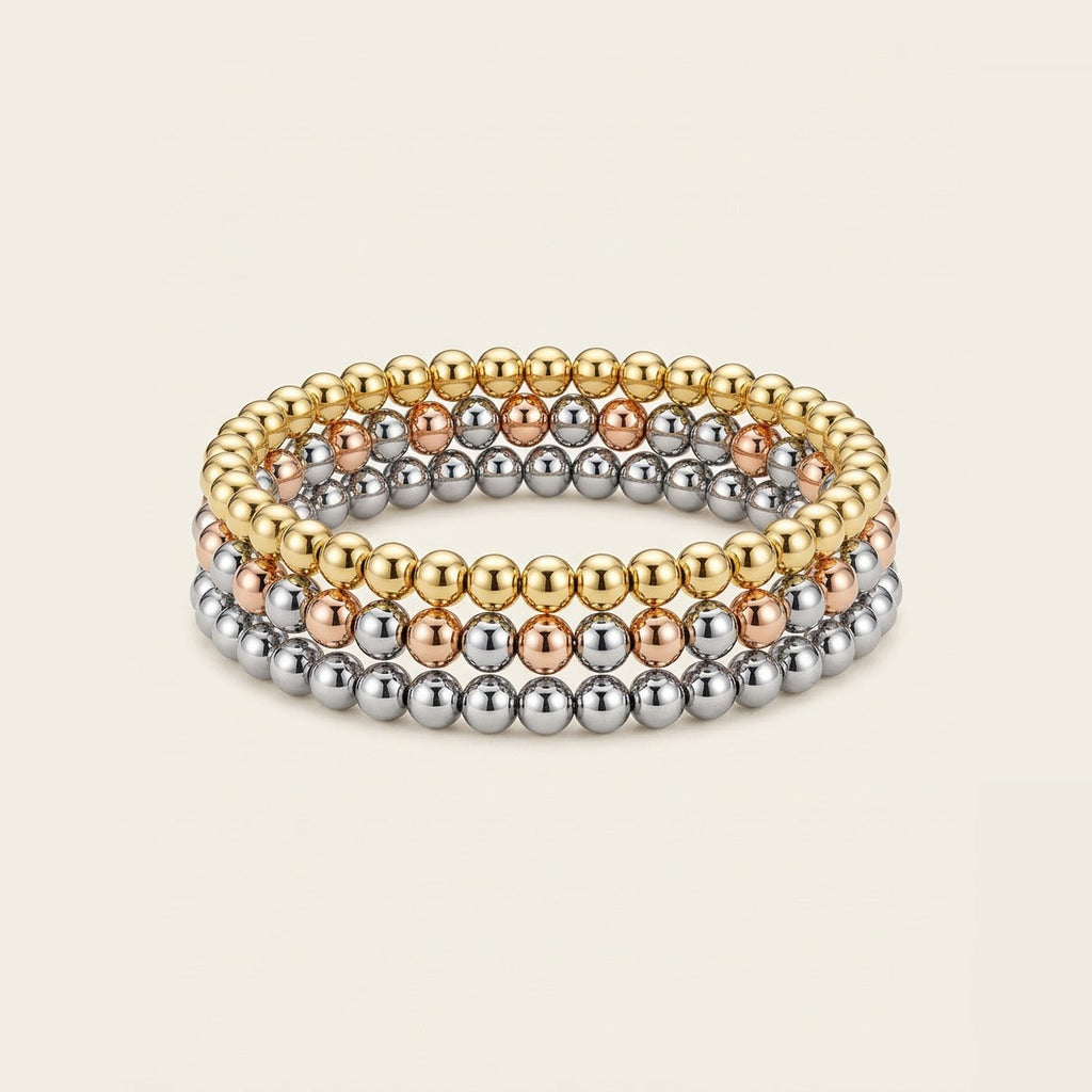 Beaded Stretch Bracelet Trio in Mixed metal, worn stacked on the wrist.