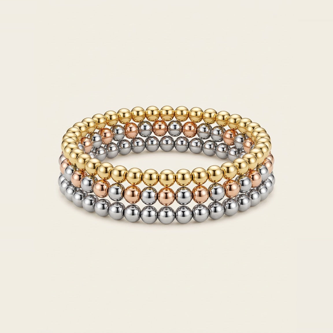 Beaded Stretch Bracelet Trio in Mixed metal, worn stacked on the wrist.