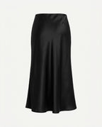Black satin midi skirt worn, showing the fluted hem