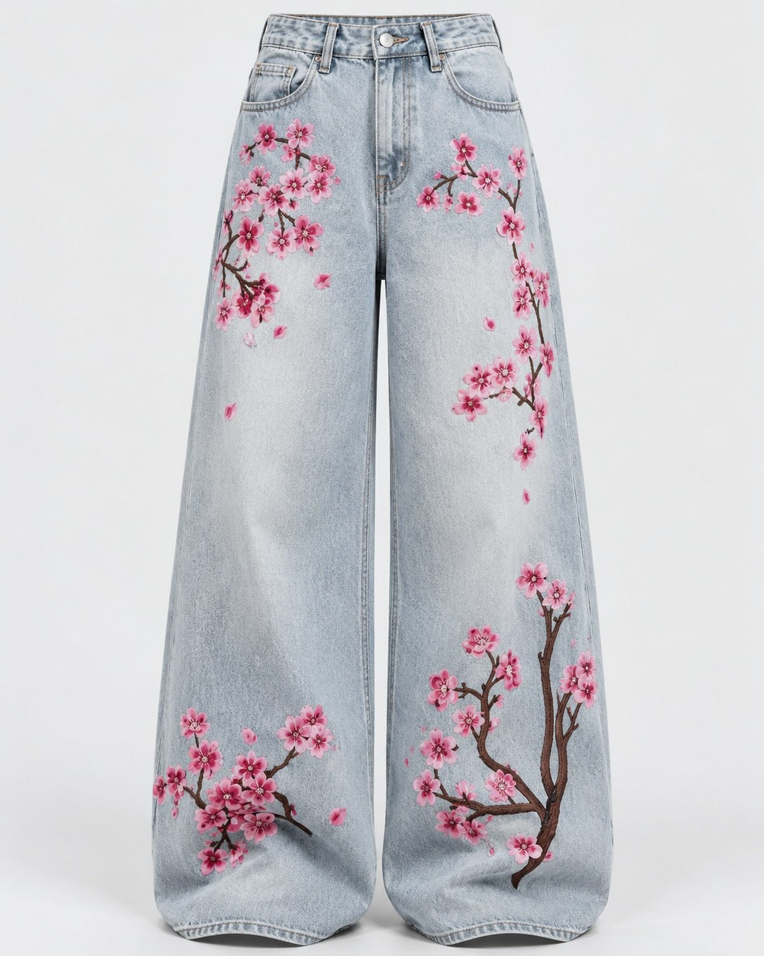 Washed indigo mid-rise jeans with floral embroidery along the leg, front view
