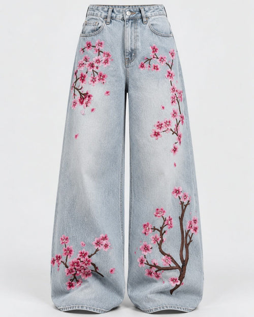 Washed indigo mid-rise jeans with floral embroidery along the leg, front view