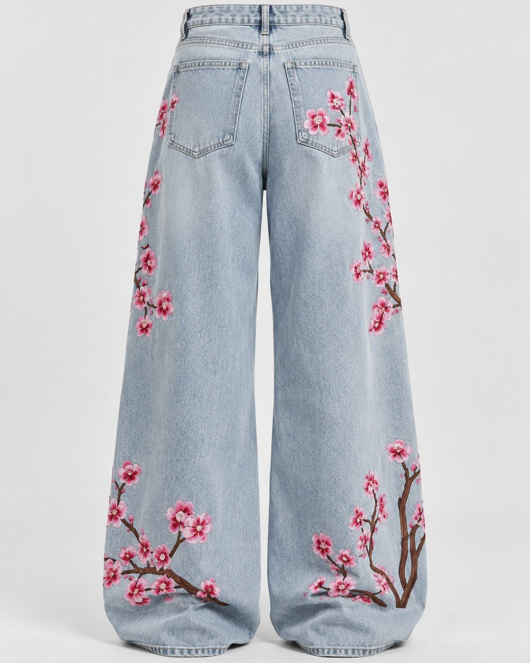 Close-up of tonal floral embroidery on washed indigo denim jeans