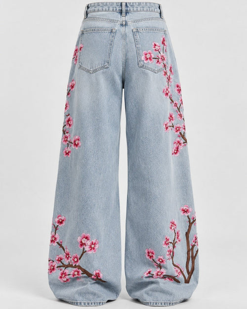 Close-up of tonal floral embroidery on washed indigo denim jeans