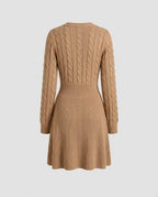 Camel cable knit dress showing the flared skirt and waist seam