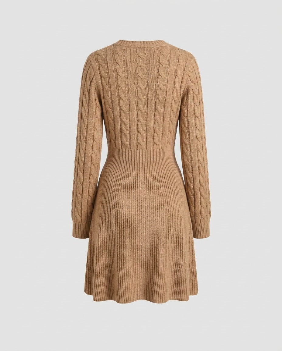 Camel cable knit dress showing the flared skirt and waist seam