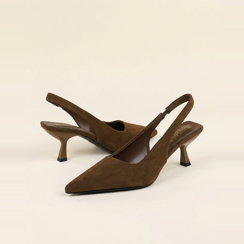 Pair of chocolate faux suede slingback pumps with pointed toes resting on a box