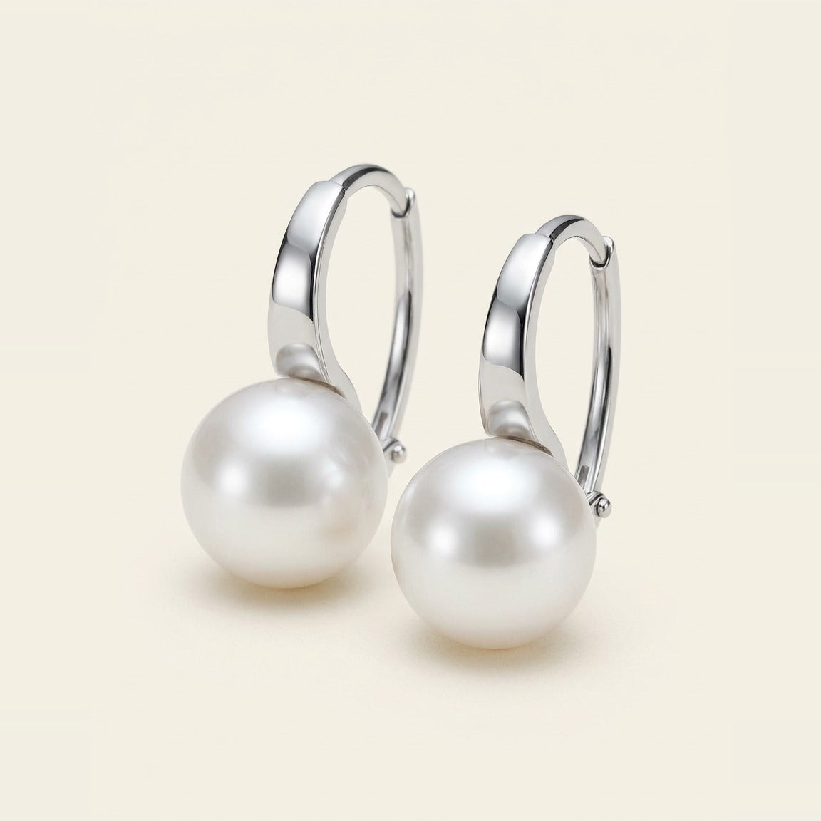 Classic white pearl drop earrings on silver-tone metal hook.