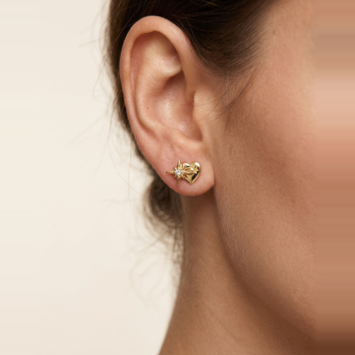 Delicate eight-pointed star stud earring in Gold, post and closure visible.
