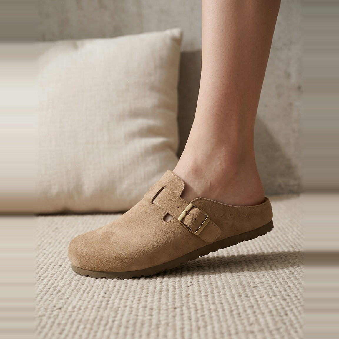 Foot wearing the Taupe Faux Suede Mule, showing the buckle detail.