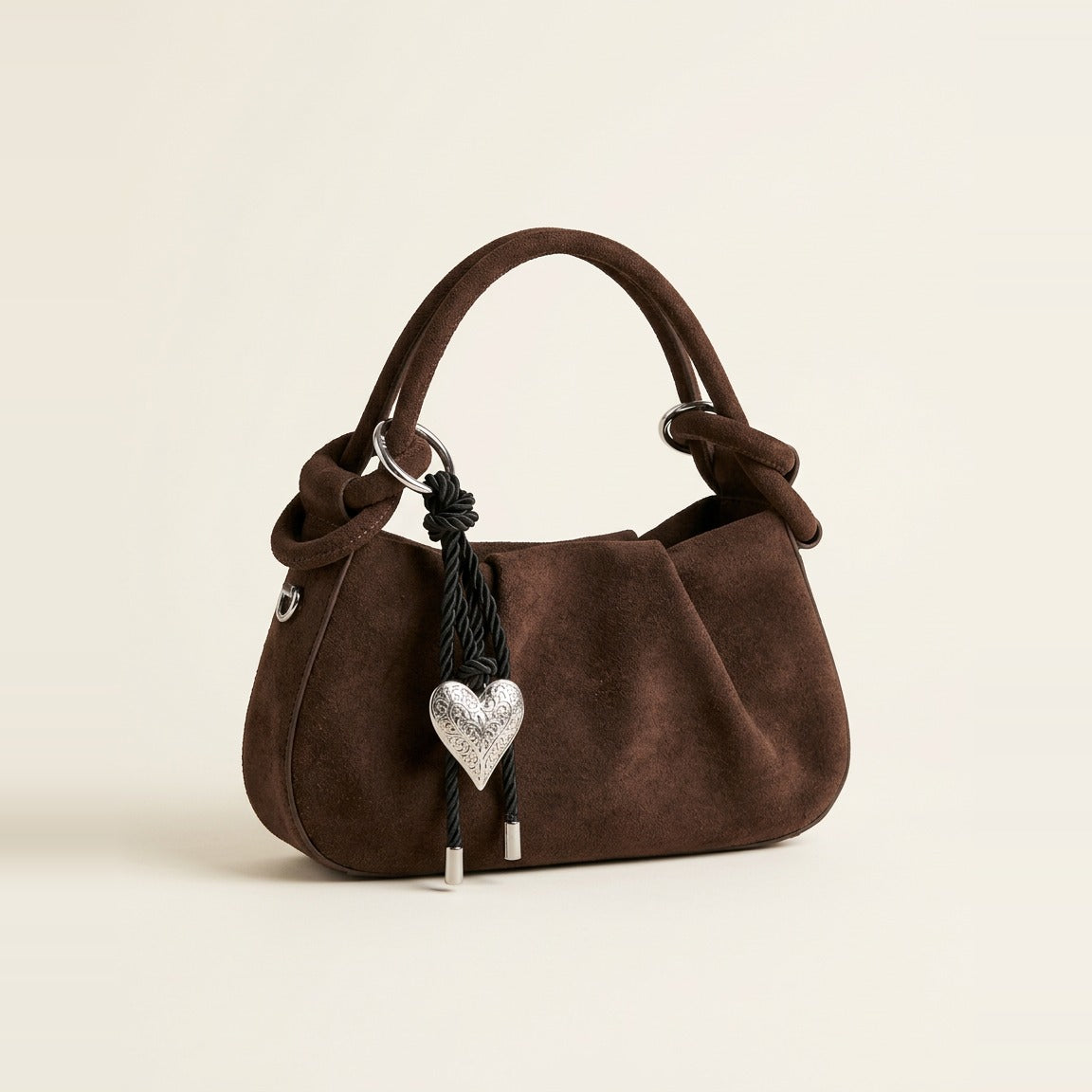 Faux Suede Knot Hobo Bag in Chocolate held by hand.