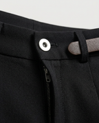 Pleated Tailored Shorts in Black, waistband with large button and belt loop, detail view