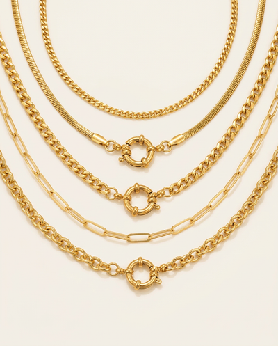 Close-up view of five assorted Gold link necklaces