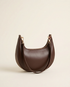 Studio hero shot of the crescent shoulder bag in chocolate against a white panel