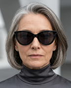 Worn side angle of cat-eye sunglasses in black.