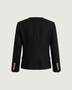 Back view of black collarless jacket with straight hem