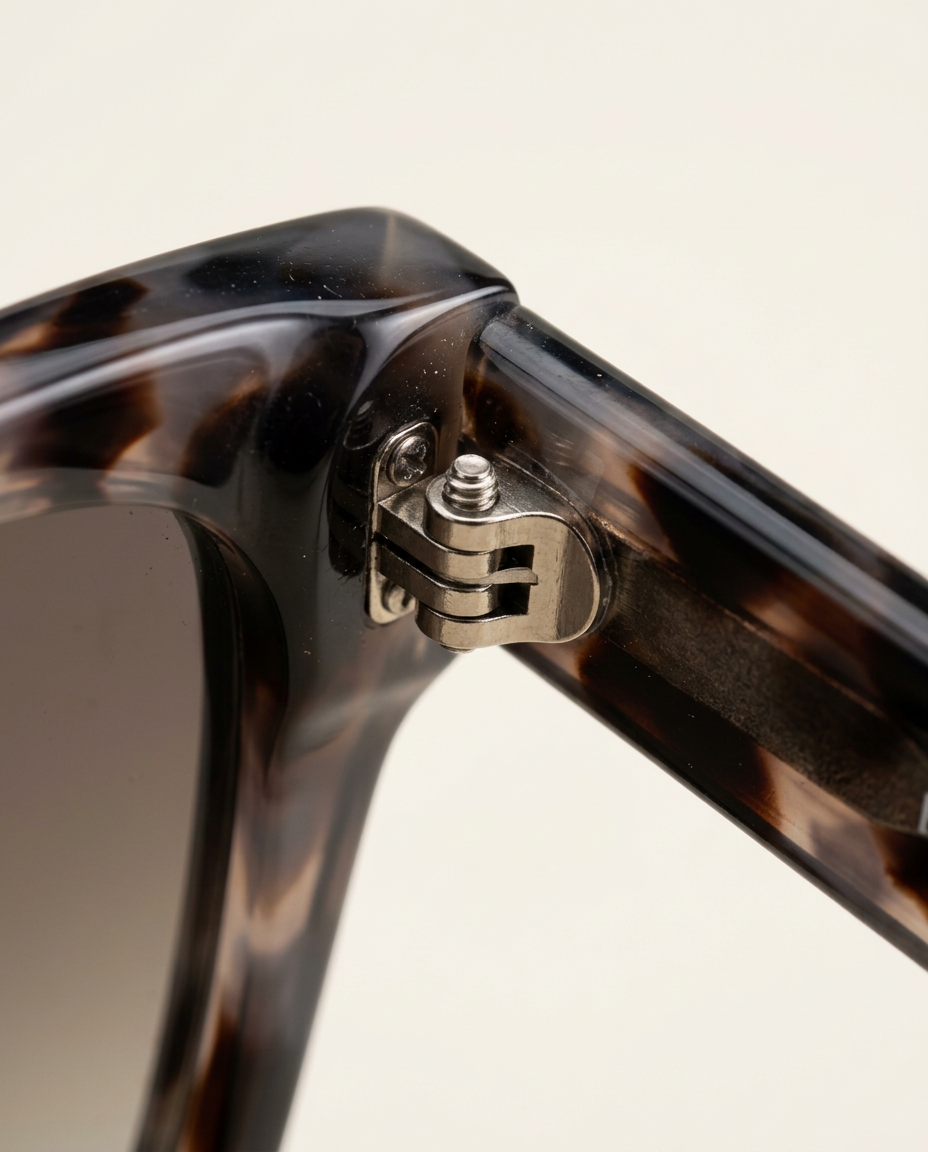 Close-up of the polished frame and tinted lenses in taupe tortoise