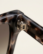 Close-up of the polished frame and tinted lenses in taupe tortoise