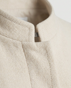 Collarless Coat in Cream, stand-up neckline and hidden front closure, detail view