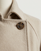 Long Double-Breasted Coat in Cream, notched lapel and button, detail view
