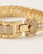 Detail of the polished metal settings and paved links in Gold.
