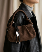 Close-up of the knotted strap and metal hardware on the Chocolate bag.