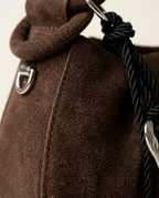 Detail of the decorative rope tassel and silver-tone heart charm on the Chocolate bag.