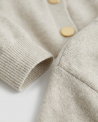 Fine Gauge Button Cardigan in Oatmeal, gold-tone buttons and ribbed cuff, detail view