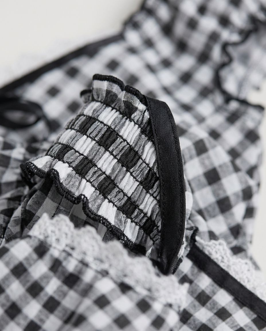 Gingham Corset Top in Black, gingham panel with smocked ruffle strap and lace trim, detail view