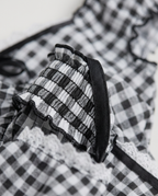 Gingham Corset Top in Black, gingham panel with smocked ruffle strap and lace trim, detail view