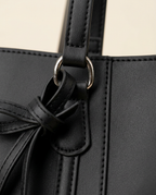 Close-up of the smooth black finish and vertical seamed strap construction