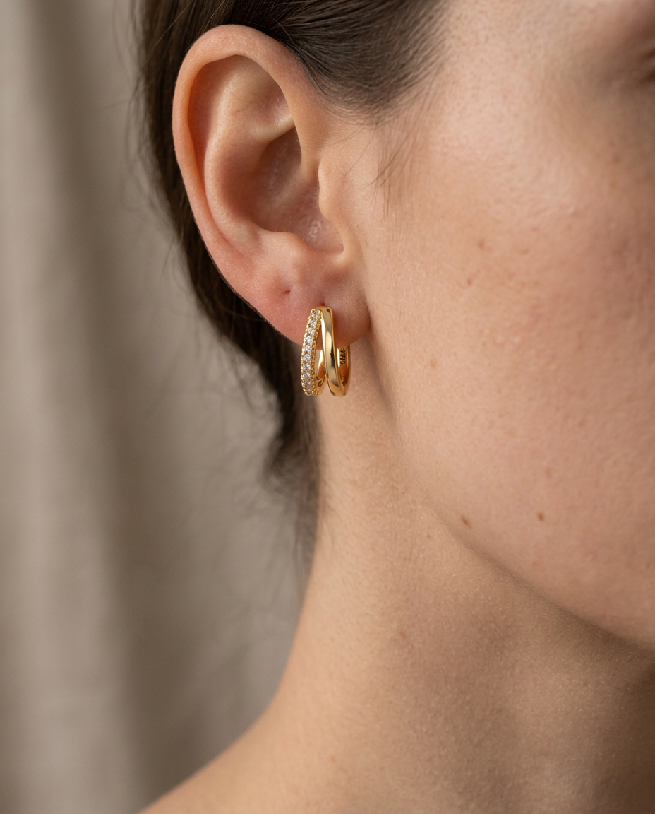 Close-up of the pavé stone line on the huggie hoop in Gold.