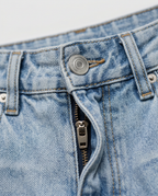 Relaxed Wide-Leg Jeans in Washed Denim Blue, light wash waistband with metal button and zip fly, detail view
