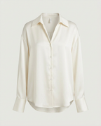 Front view of the satin relaxed button-down shirt in cream on a hanger