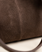 Close-up of the soft nap finish and matching detachable pouch in Chocolate