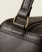 Macro view of the front slip pocket and tonal stitching in Chocolate