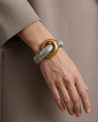Interlocking tubogas bracelet in silver worn on the wrist.