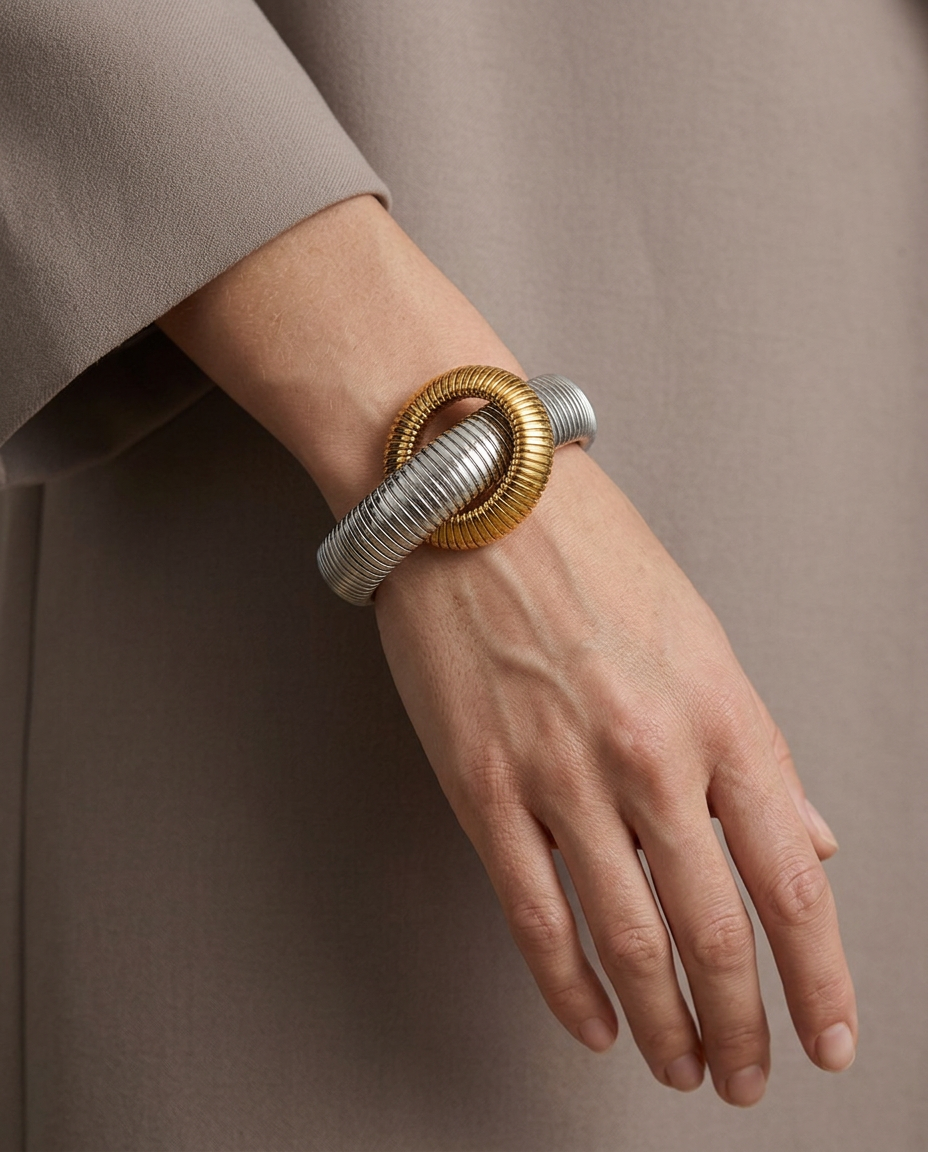 Interlocking tubogas bracelet in silver worn on the wrist.