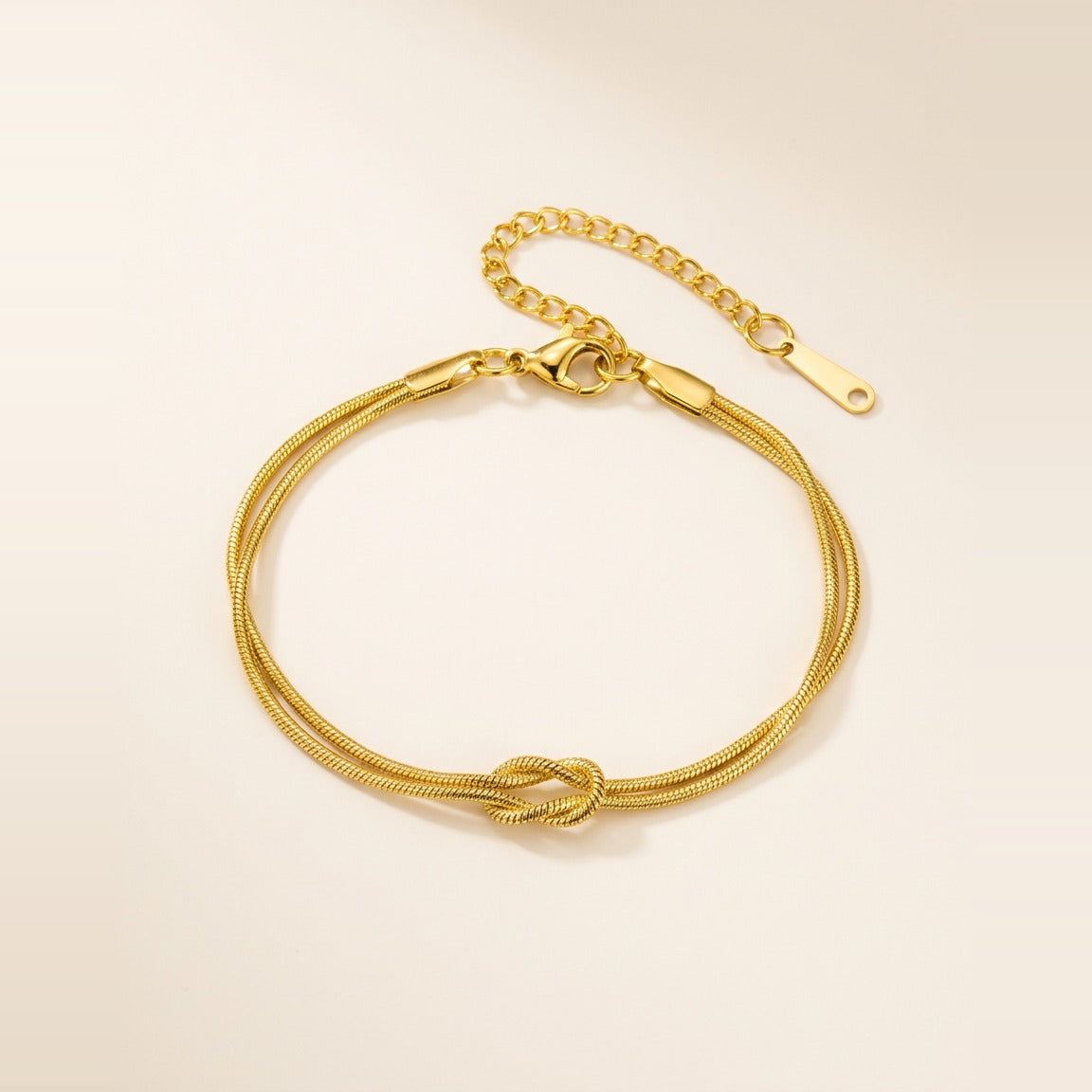 Love Knot Chain Bracelet in Gold, shown flat.