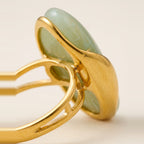 Polished gold-tone setting holding the Cognac marbled stone.