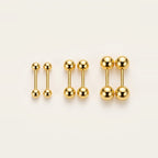 Mini Ball Stud Earrings in Gold, worn on the earlobe.