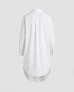 White shirtdress silhouette showing the curved hemline