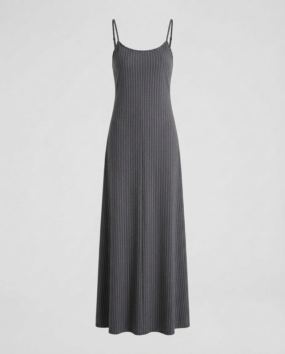 Grey pinstripe midi slip dress worn over a knit top.