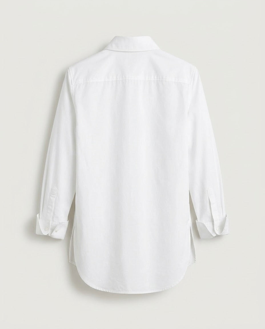 Back view of relaxed poplin shirt in white with dropped shoulders and curved hem