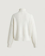 Cream ribbed turtleneck showing the wide ribbed hem
