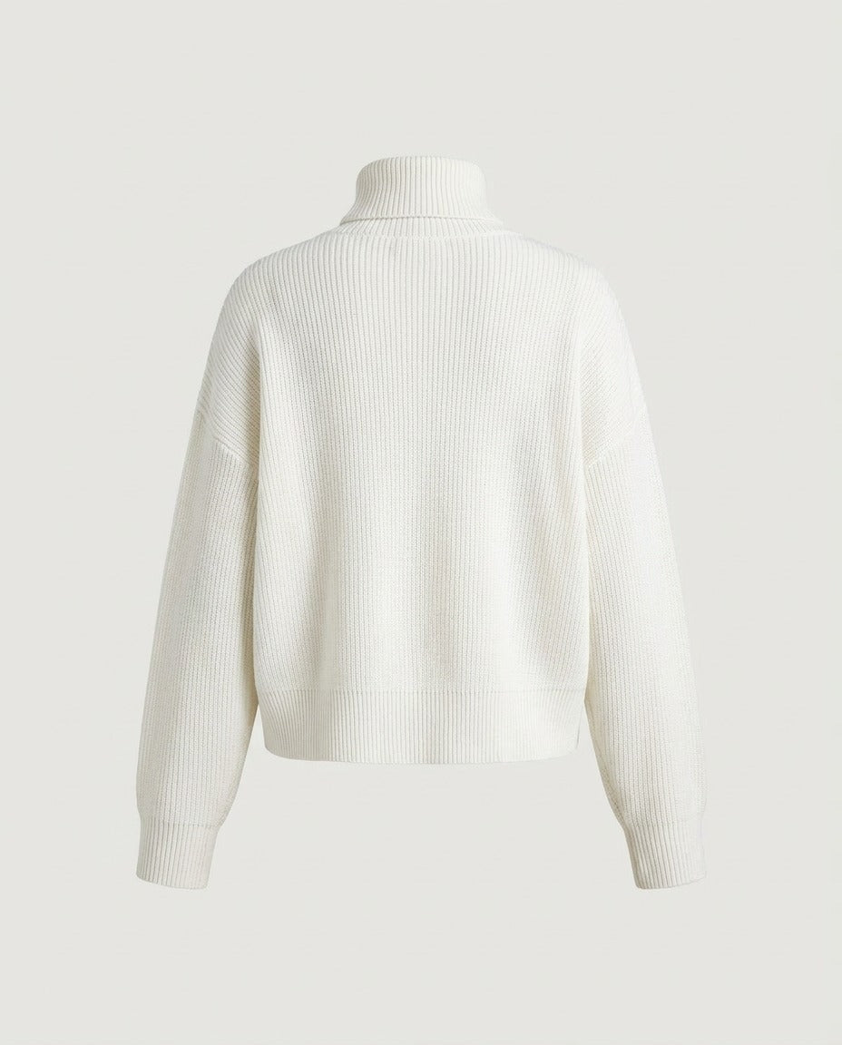 Cream ribbed turtleneck showing the wide ribbed hem