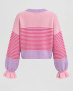 Detail of soft ruffle trim on fine-gauge knit cardigan placket